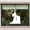 Grim reaper raamsticker met een gedaante met zeis naast een grafsteen
