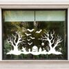 Halloween rand raamsticker van 100 x 50 cm met kale bomen, vleermuizen en een pompoen