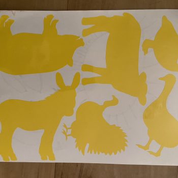 a yellow animal cutouts on a white surface