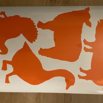 a white and orange sticker with animals on it