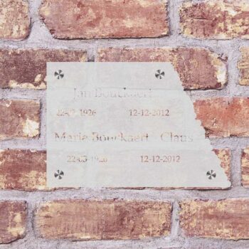 a white sign on a brick wall