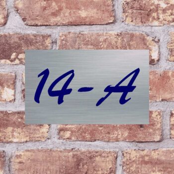 a metal sign on a brick wall