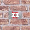 RVS naambord T42 2 a sign on a brick wall