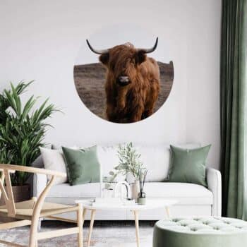 a room with a couch and a picture of a cow