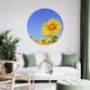 Muurcirkel zonnebloem 5 a room with a couch and a picture of a sunflower