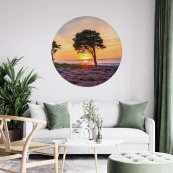 a room with a couch and a picture of a tree