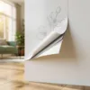 Witte muursticker met elegante bloemmotieven die loslaat in de hoek, op eiken vloer in moderne Nederlandse woning