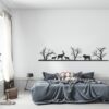 Muursticker herten en leeuw boven het bed in de slaapkamer